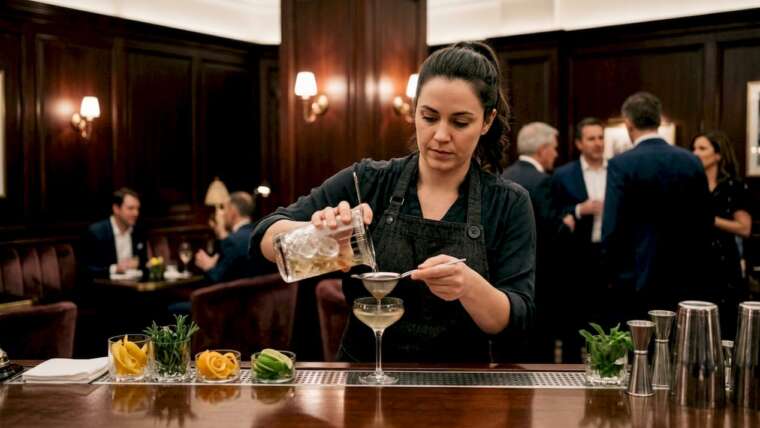 Bartender pouring cocktail at upscale bar