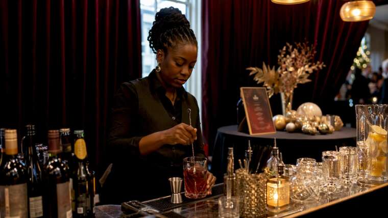 Bartender arranging festive corporate holiday party bar