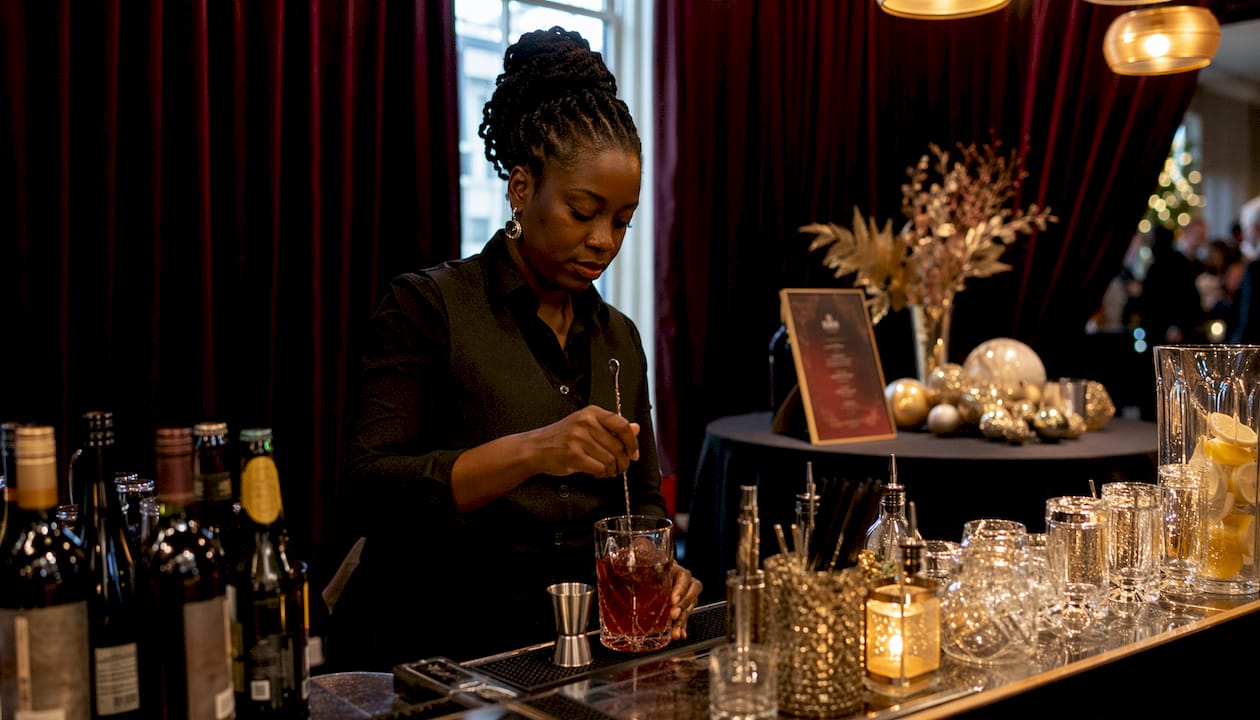 Bartender arranging festive corporate holiday party bar