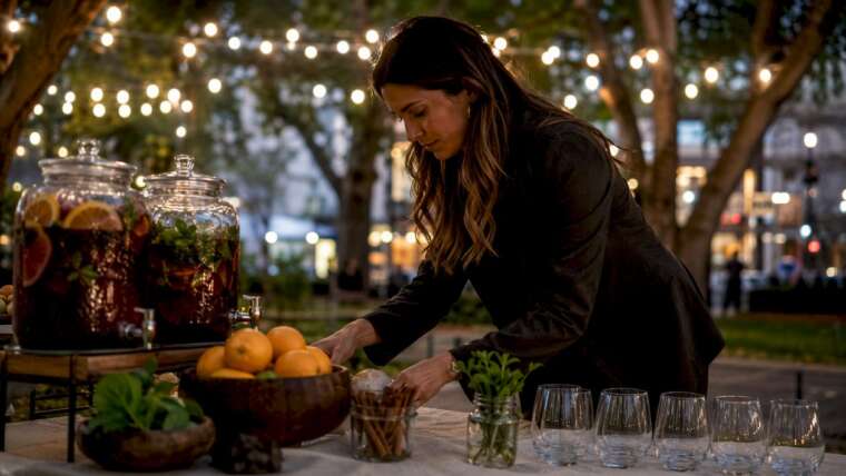 Event planner setting up sangria bar outdoors