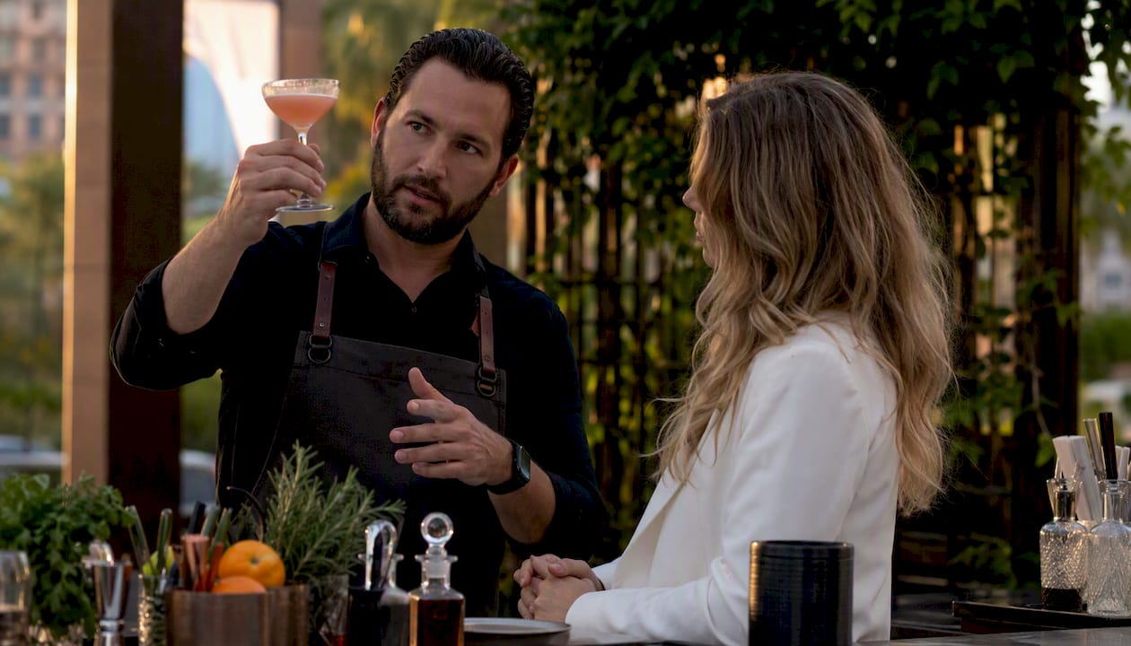 Mixologist presenting cocktail during tasting