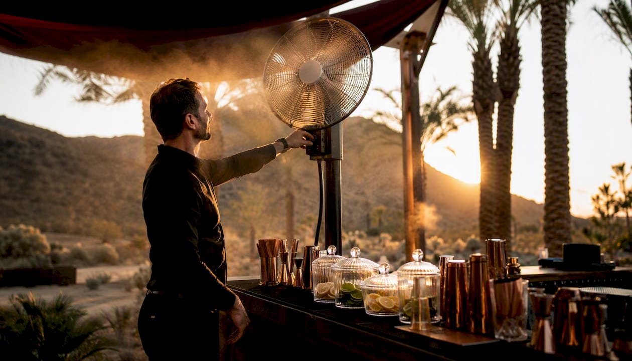 Misting fan cooling outdoor bar at wedding