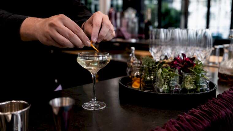 Bartender pouring and garnishing wedding mocktail