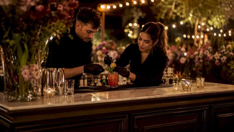 Bartenders preparing interactive cocktail station