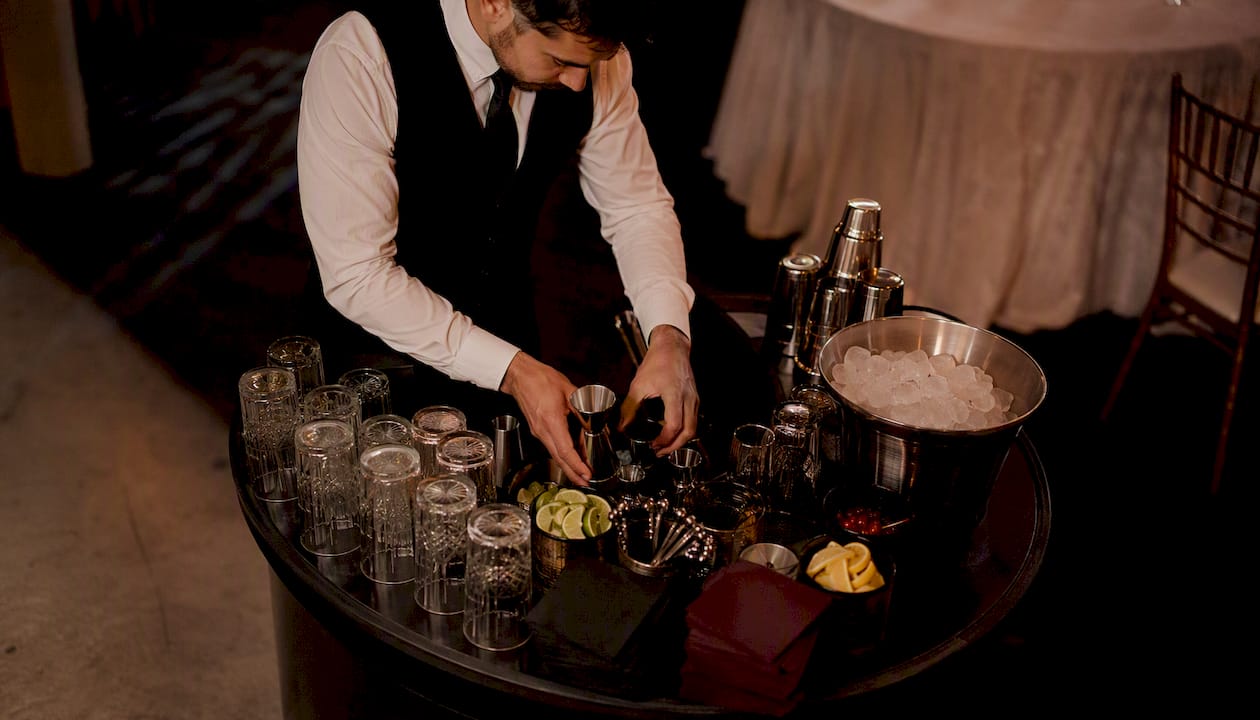 Bartender setting up bar equipment