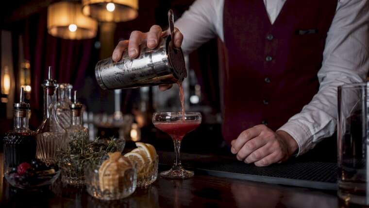 Bartender pouring cocktail at mobile bar