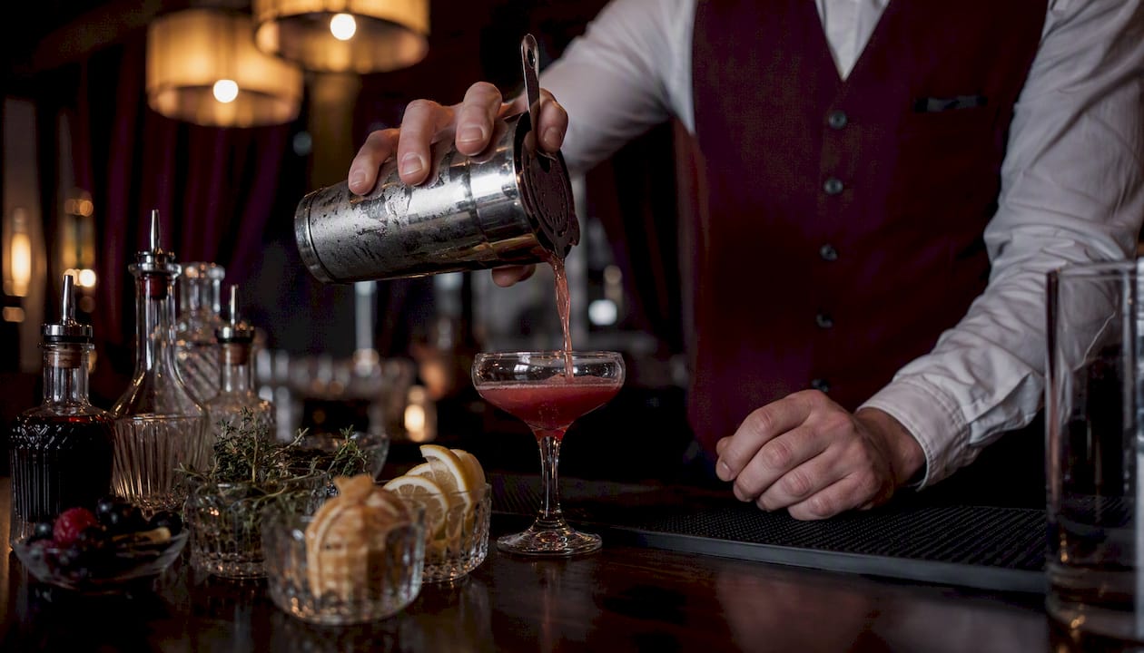 Bartender pouring cocktail at mobile bar