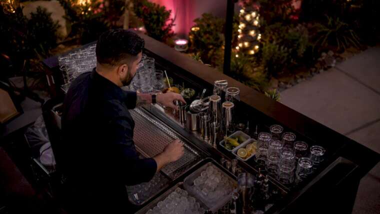 Bartender setting up mobile bar at event venue