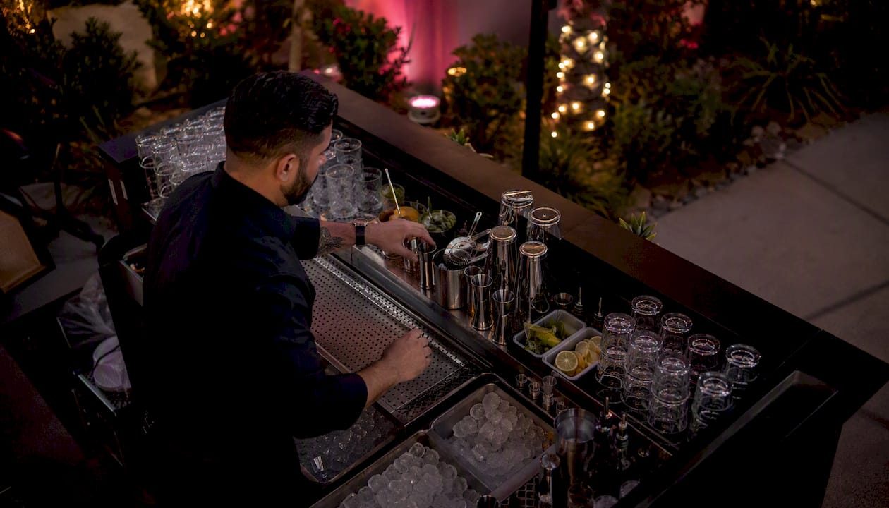 Bartender setting up mobile bar at event venue