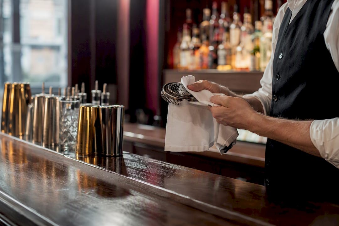 Bartender sanitizing cocktail utensils
