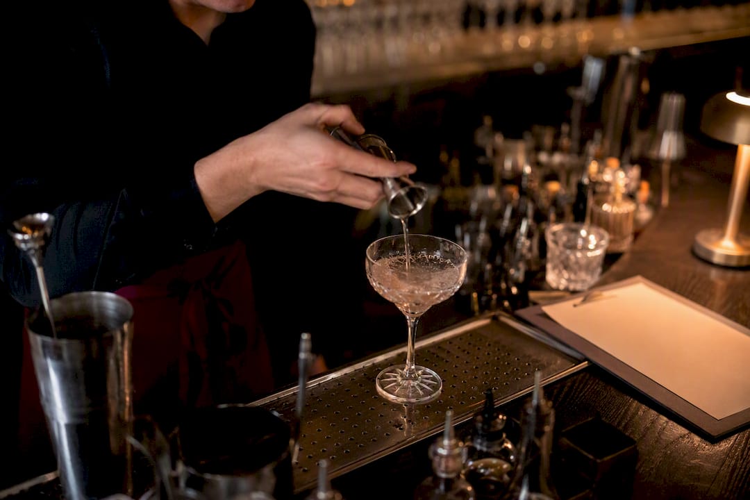Bartender pouring allergy-friendly cocktail