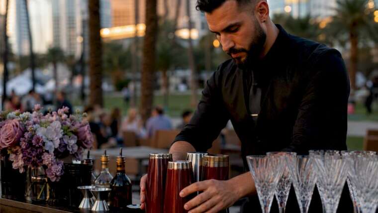 Bartender setting up mobile bar outdoors in park