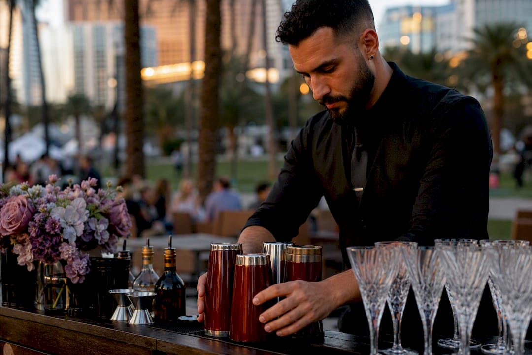 Bartender setting up mobile bar outdoors in park