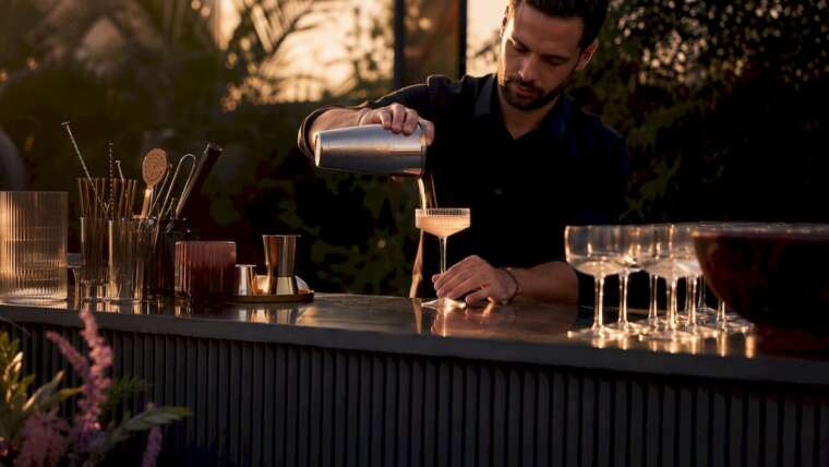 Bartender pouring cocktail at mobile bar