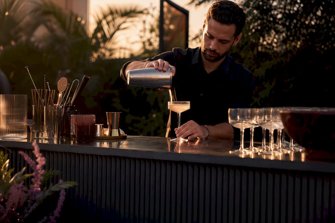 Bartender pouring cocktail at mobile bar