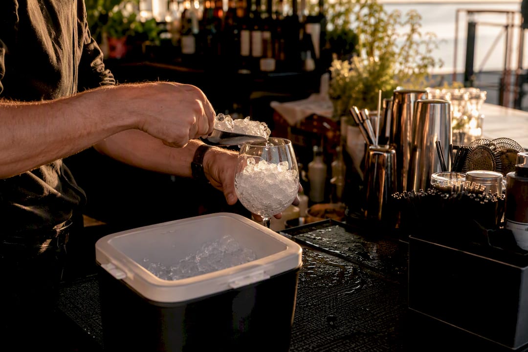 Bartender scooping ice into glass