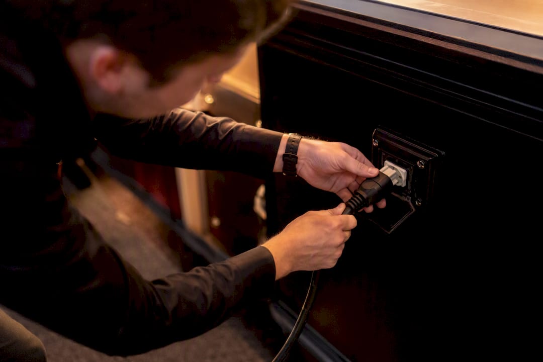 Bartender plugging extension cord into power outlet