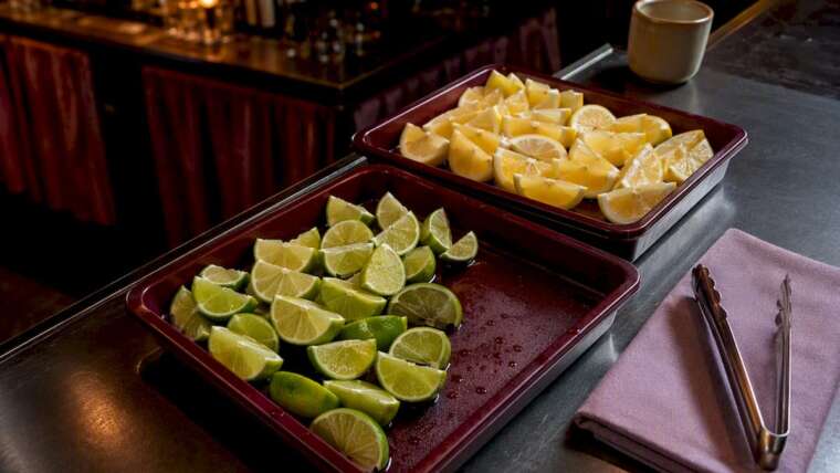 Citrus garnishes with sanitized serving tongs