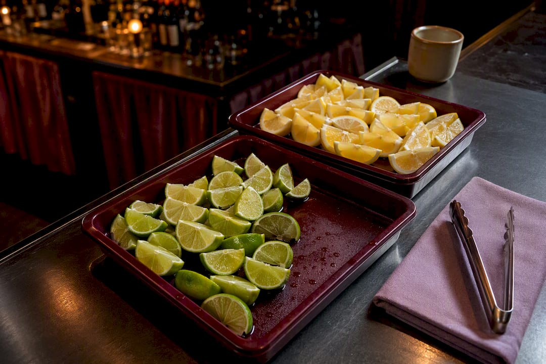 Citrus garnishes with sanitized serving tongs