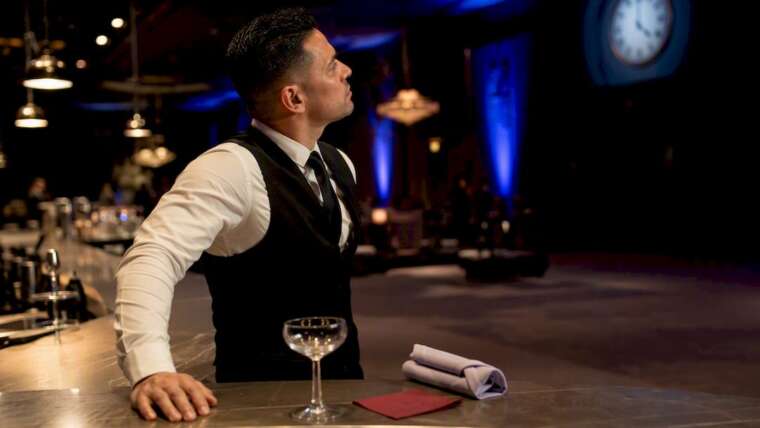 Bartender checking service time at event bar
