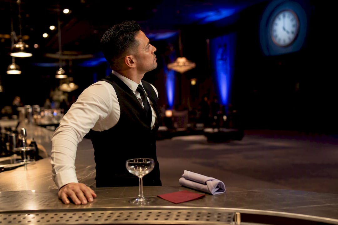Bartender checking service time at event bar