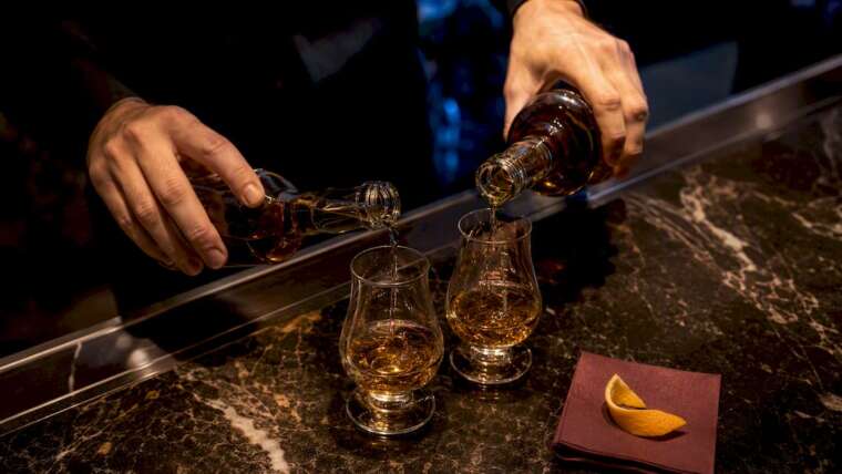 Bartender pouring premium spirits at event bar