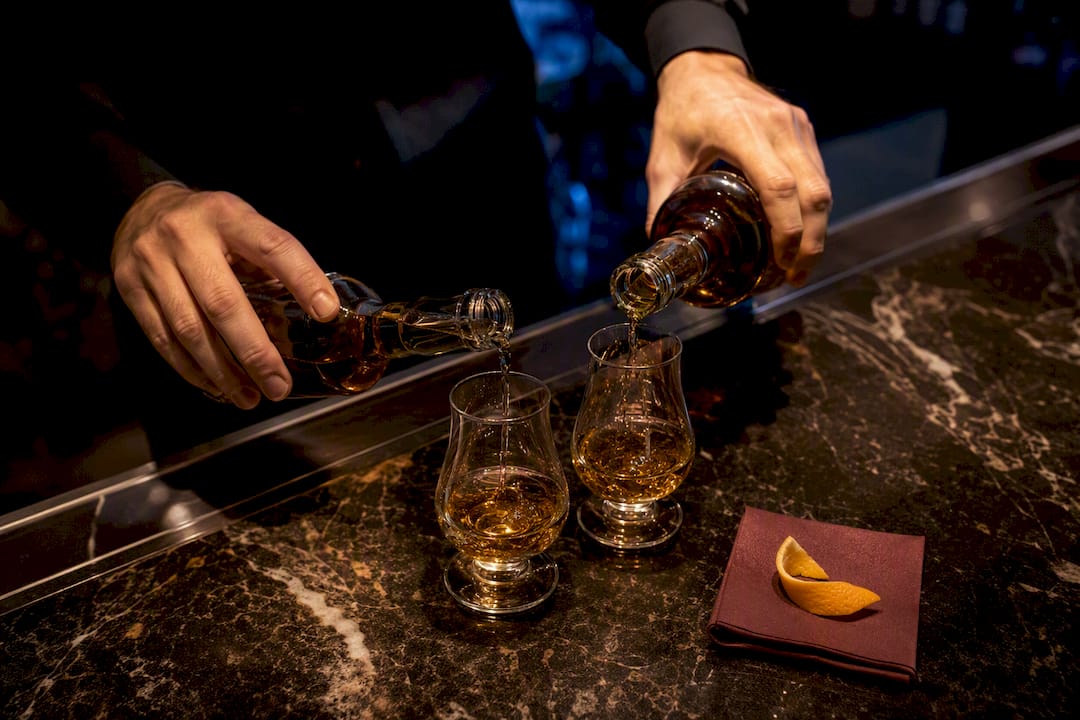 Bartender pouring premium spirits at event bar