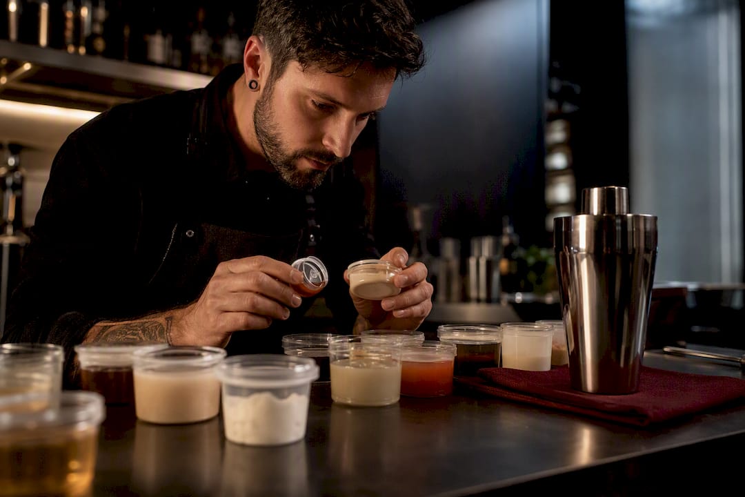 Bartender checking vegan cocktail ingredients