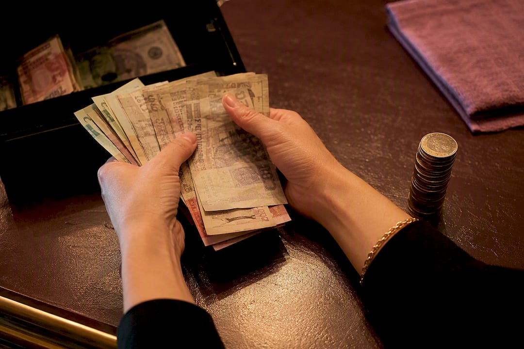 Hands counting cash after bar service