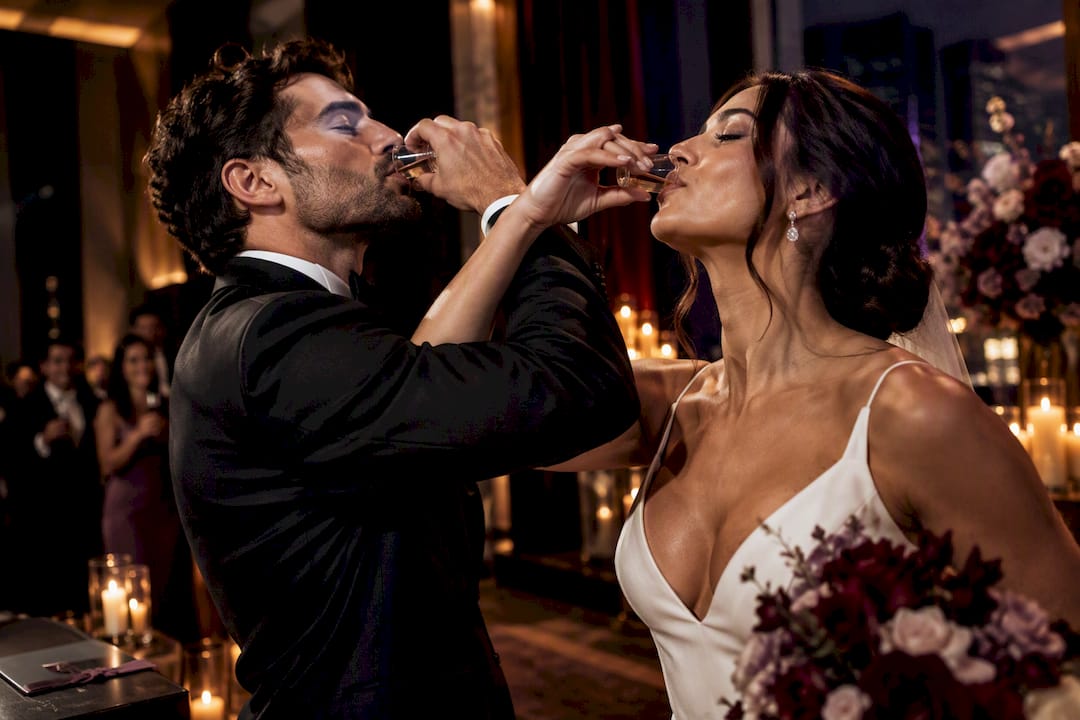 Couple performing a linked-cup wedding toast