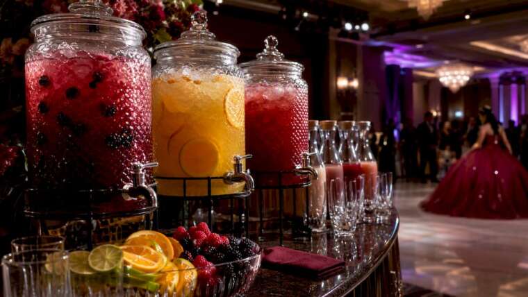 Elegant quinceañera mocktail station with colorful drinks