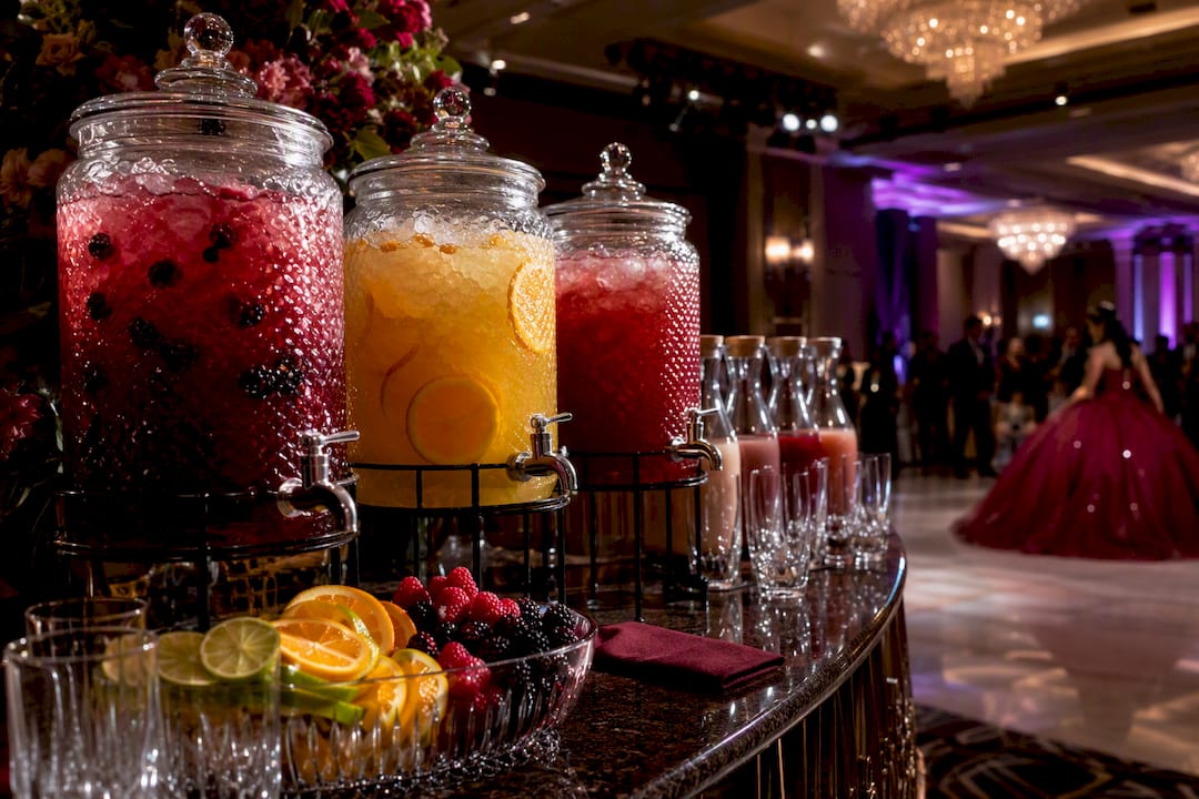 Elegant quinceañera mocktail station with colorful drinks