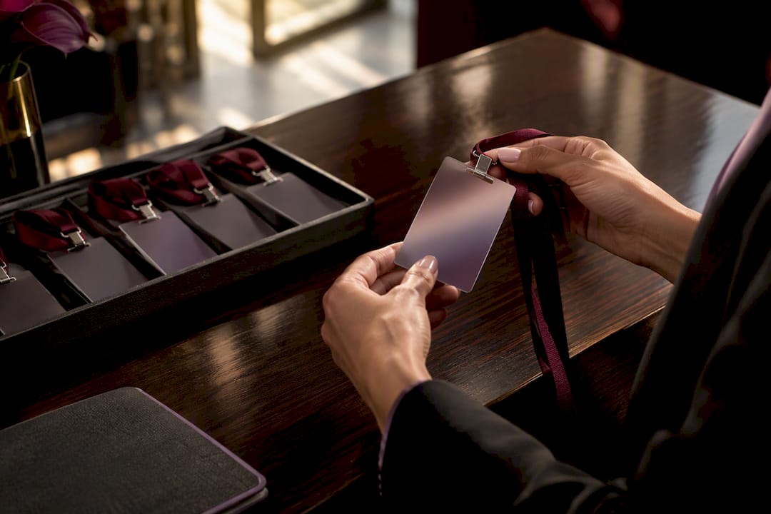 Hands verifying staff credential before event