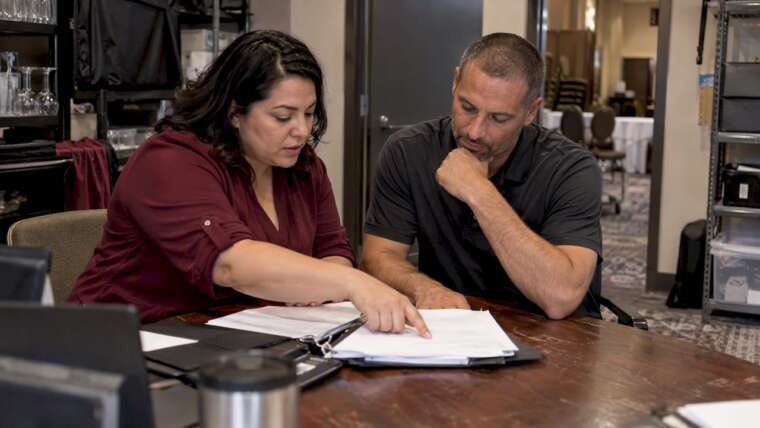 Venue managers reviewing insurance certificate paperwork