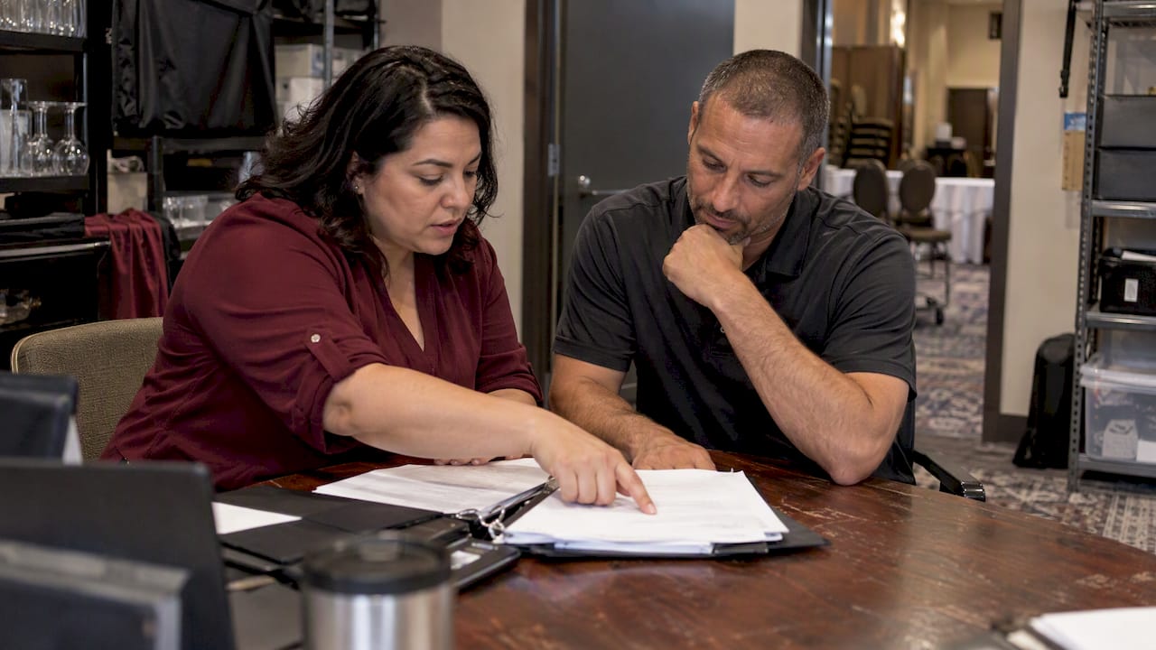 Venue managers reviewing insurance certificate paperwork